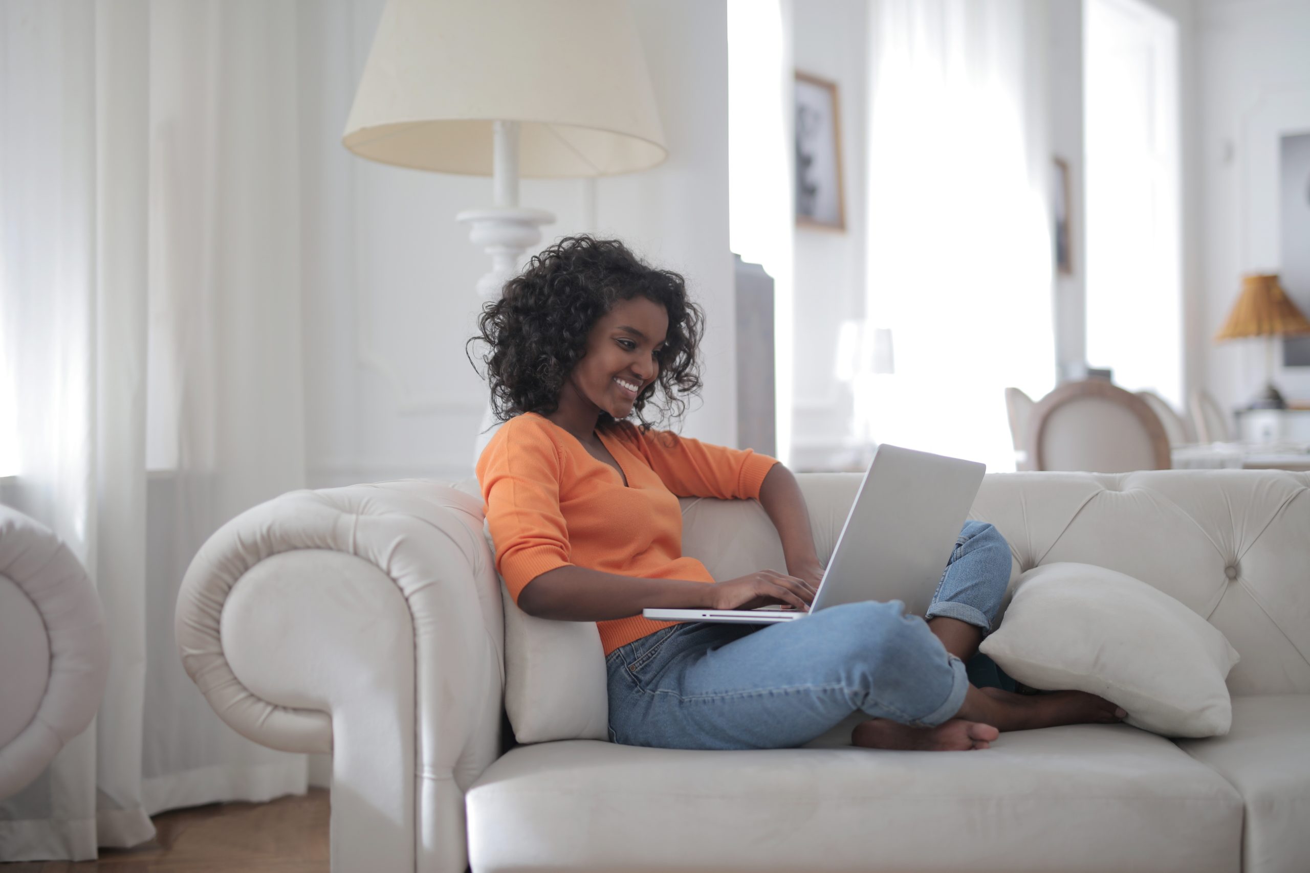 woman-sitting-on-white-couch-using-laptop-computer-3960127 woman-sitting-on-white-couch-using-laptop-computer-3960127